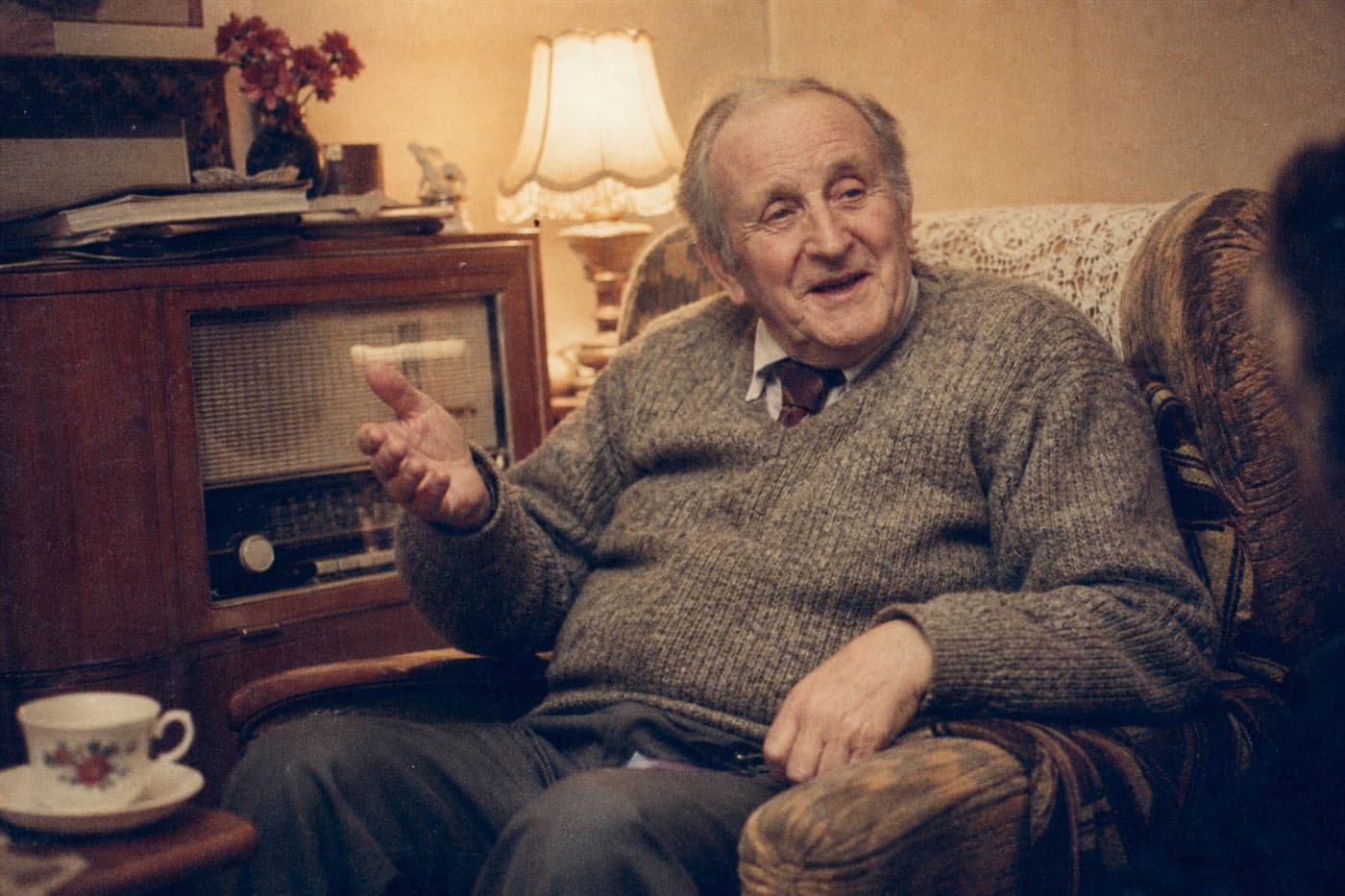 A restored family photograph of grandad telling stories, 1988